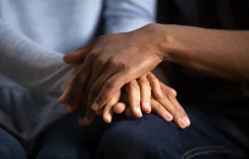 people holding hands in caring pose