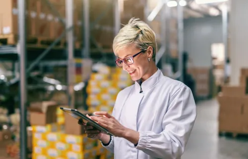 manufacturing professional using tablet in a warehouse