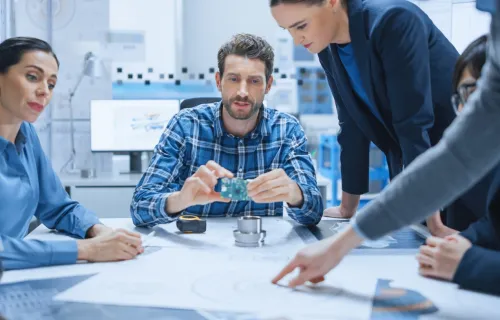 men and women working at a table