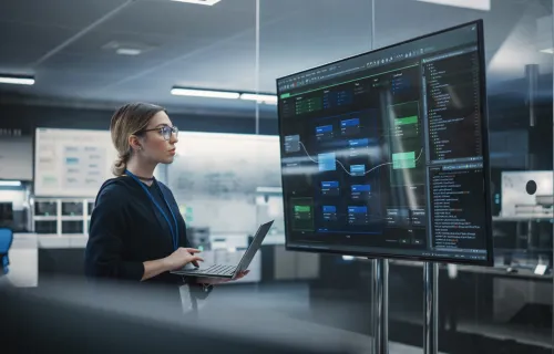 A person looking at data on a computer monitor