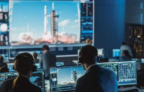 une équipe de contrôle de mission observe un lancement de fusée, représentant les solutions spatiales de CGI
