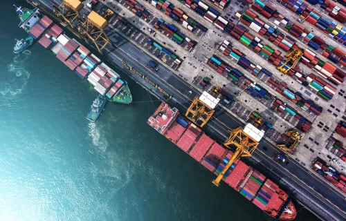 Top view of a port with cargo ship and containers