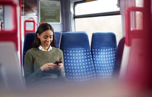 Rail passenger uses mobile device 