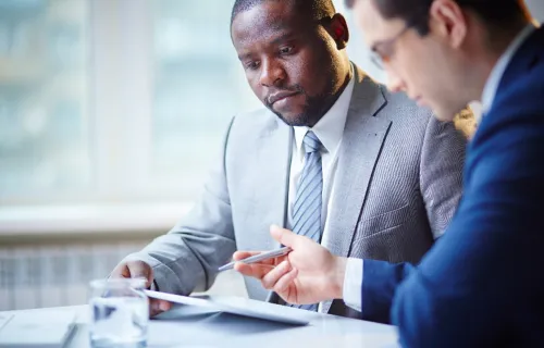 Two men consulting at the table