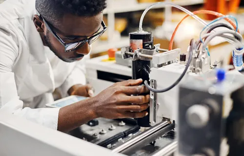 A man handling some machinery equipment 