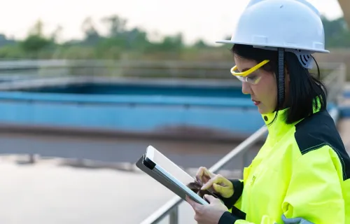 utility worker holding a tablet