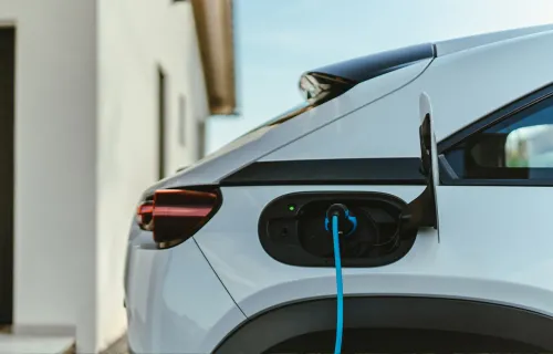 a side rear view of an electric vehicle charging 