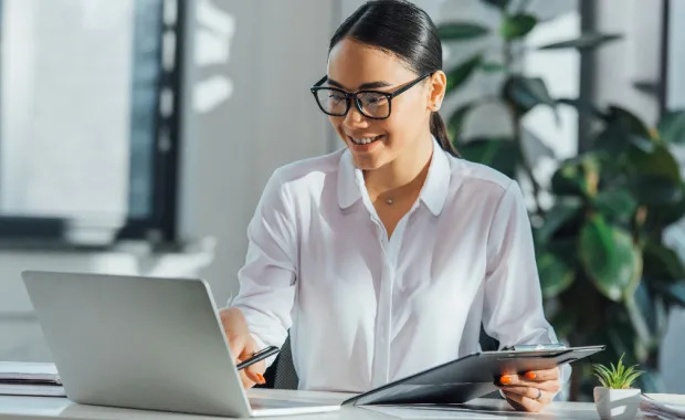 government worker checking document on laptop