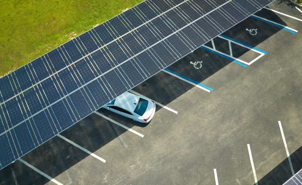 Aerial view of a car parked under solar panel covered lot