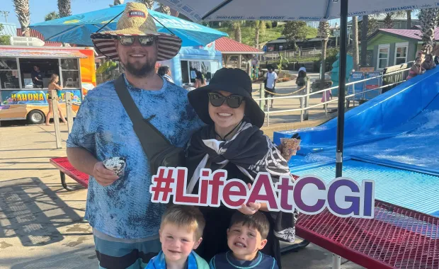 Amber Holmes and family holding #LifeAtCGI sign