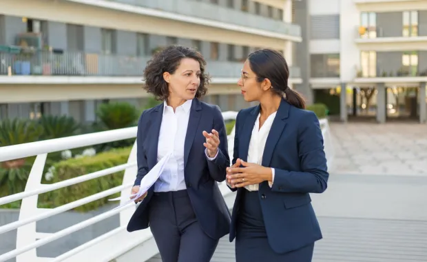 Business women walking outside in a city