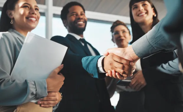 colleagues smiling, shaking hands