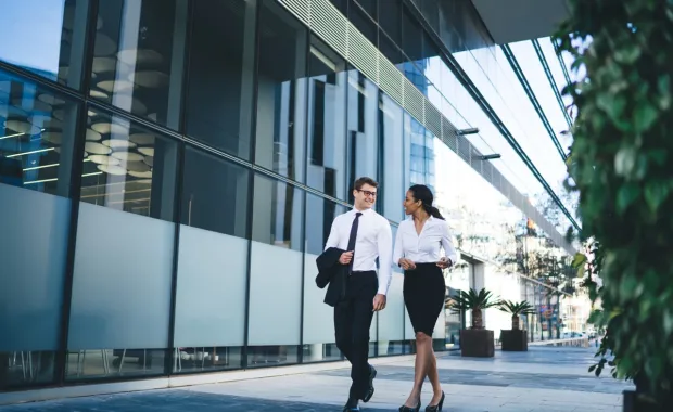 Colleagues walking and discussing business