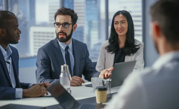 A team is meeting in a conference room having a meeting