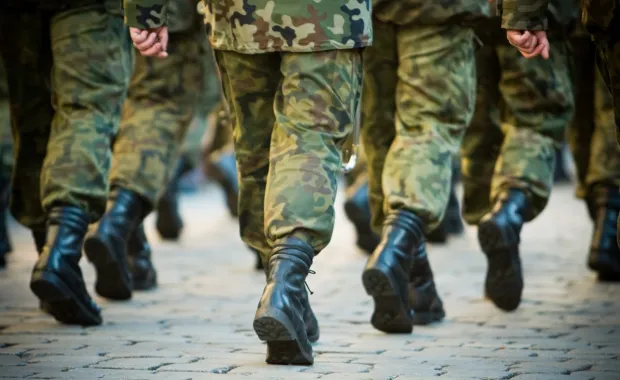 Close up of army veterans marching 