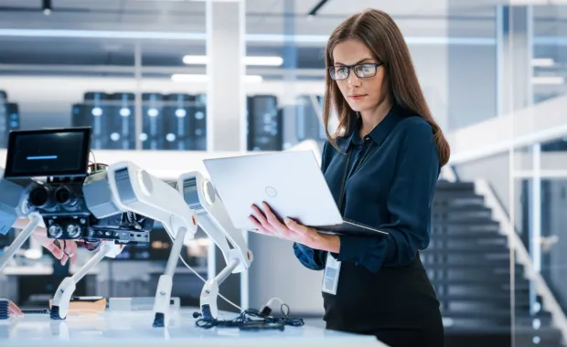 Executive on a laptop in a lab