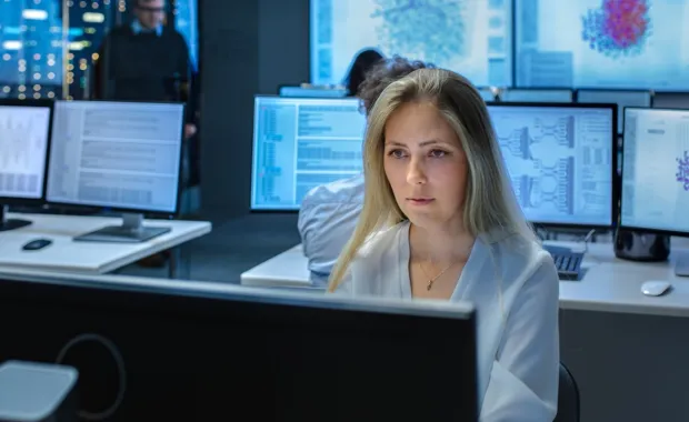 Female insurance engineer working on an AI project in a computer lab