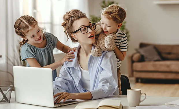 woman and two kids by laptop
