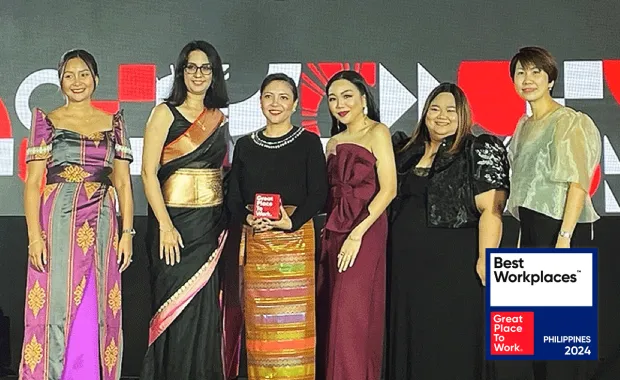 Our team in the Philippines accepts their award in the Philippines Best Workplaces Gala