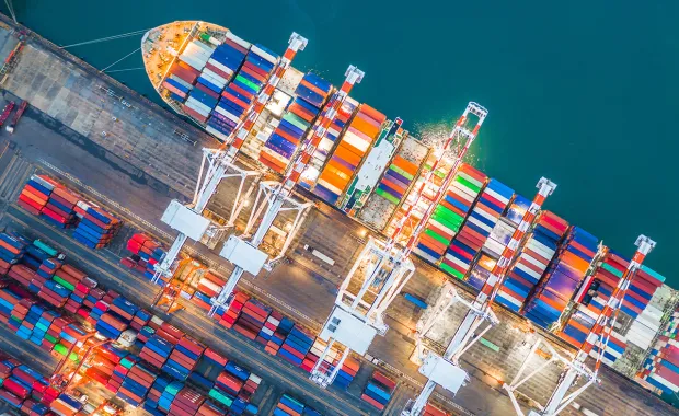 Aerial view of a docked ship carrying shipping containers