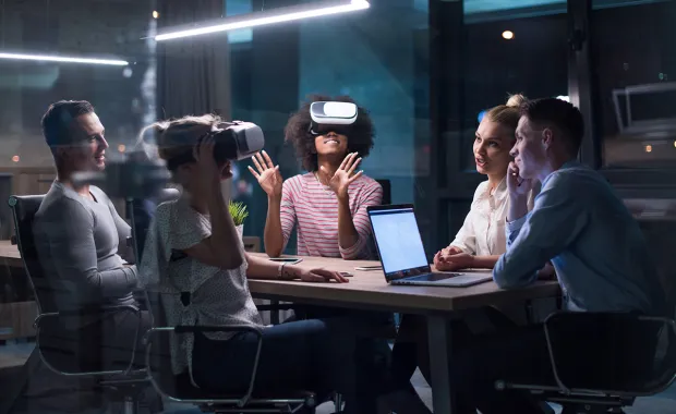 people wearing VR headset around a table