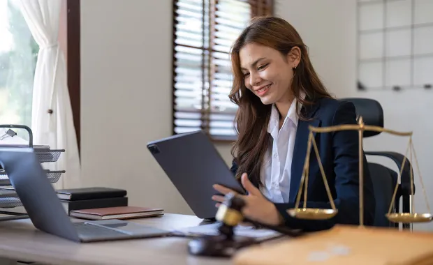 consultant on a laptop examining legal documents