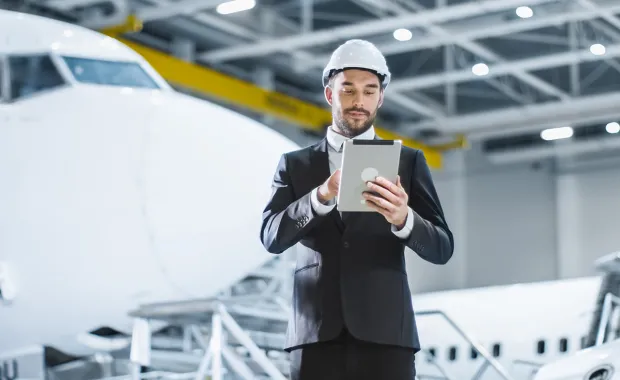 Aerospace engineer holding a tab and analyzing the design