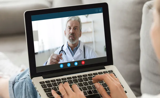 Doctor providing online consultation via video call