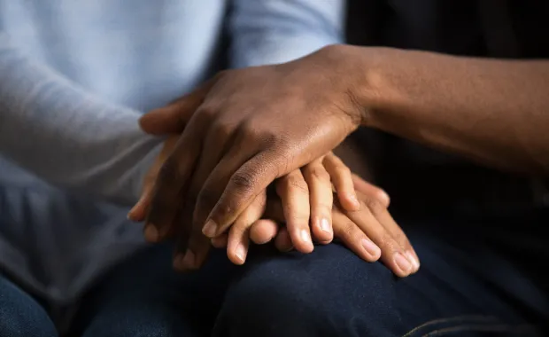 people holding hands in caring pose