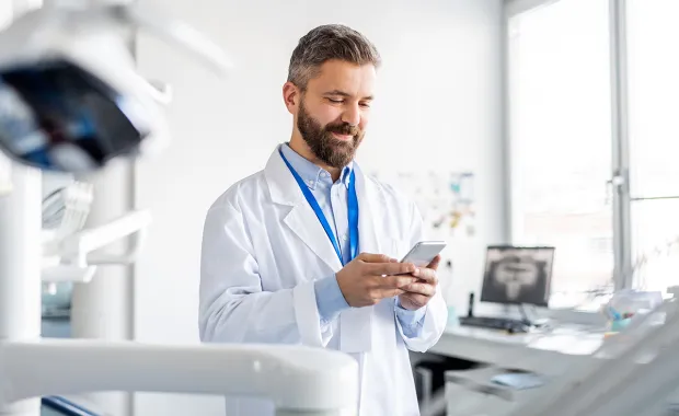 Läkare som håller i en mobiltelefon
