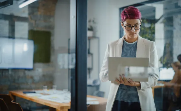 Person standing while reviewing information on a computer