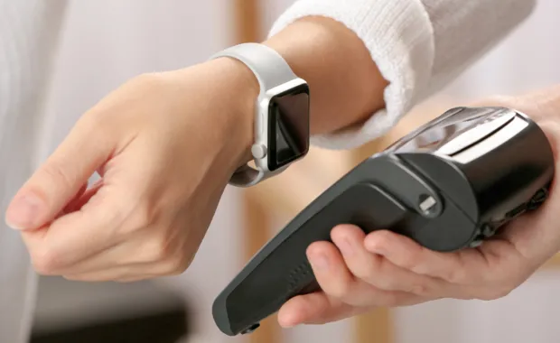 Person makes a contactless payment using their watch