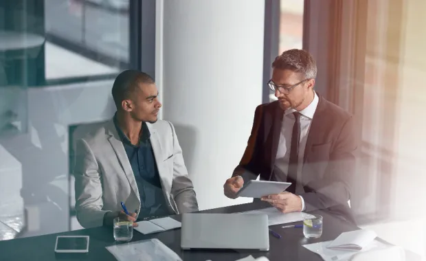 	professionals-at-desk-looking-at-documents