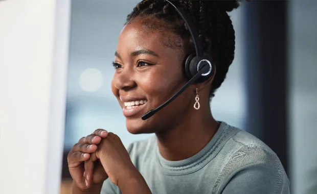 Lady smiling and wearing a headset 