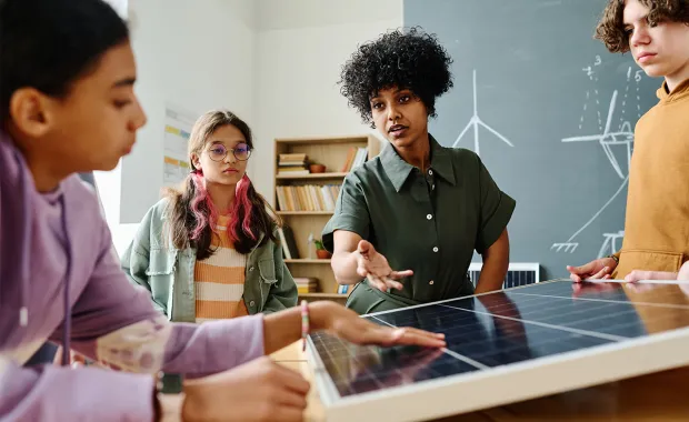 teacher working with students