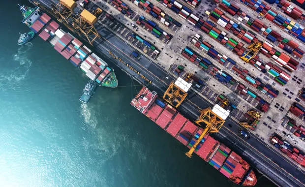 Top view of a port with cargo ship and containers