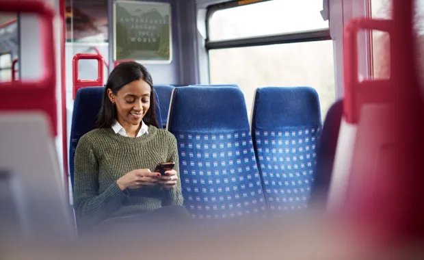 Rail passenger uses mobile device 