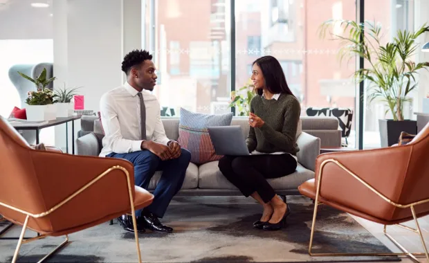 Two colleagues sitting and chatting