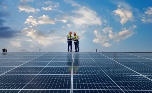 two people standing on solar panel