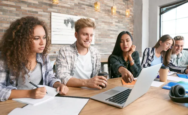 University students looking at laptop