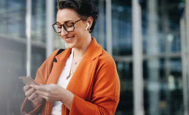 Woman smiles at phone