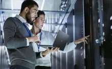 Woman and Man looking at servers in a datacenter