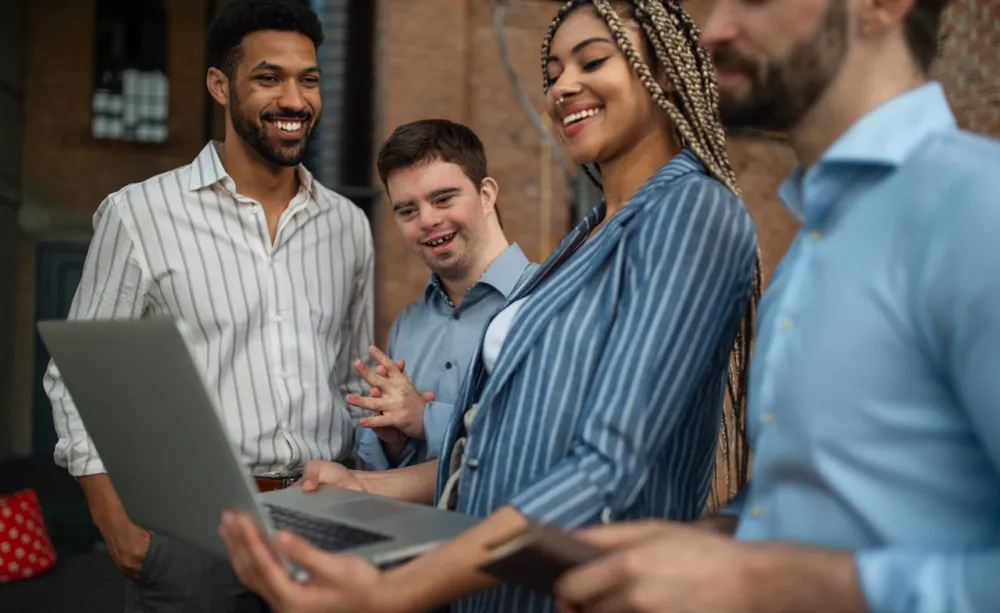 Cheerful young businesspeople with laptop working in office Cheerful young businesspeople with laptop working in office