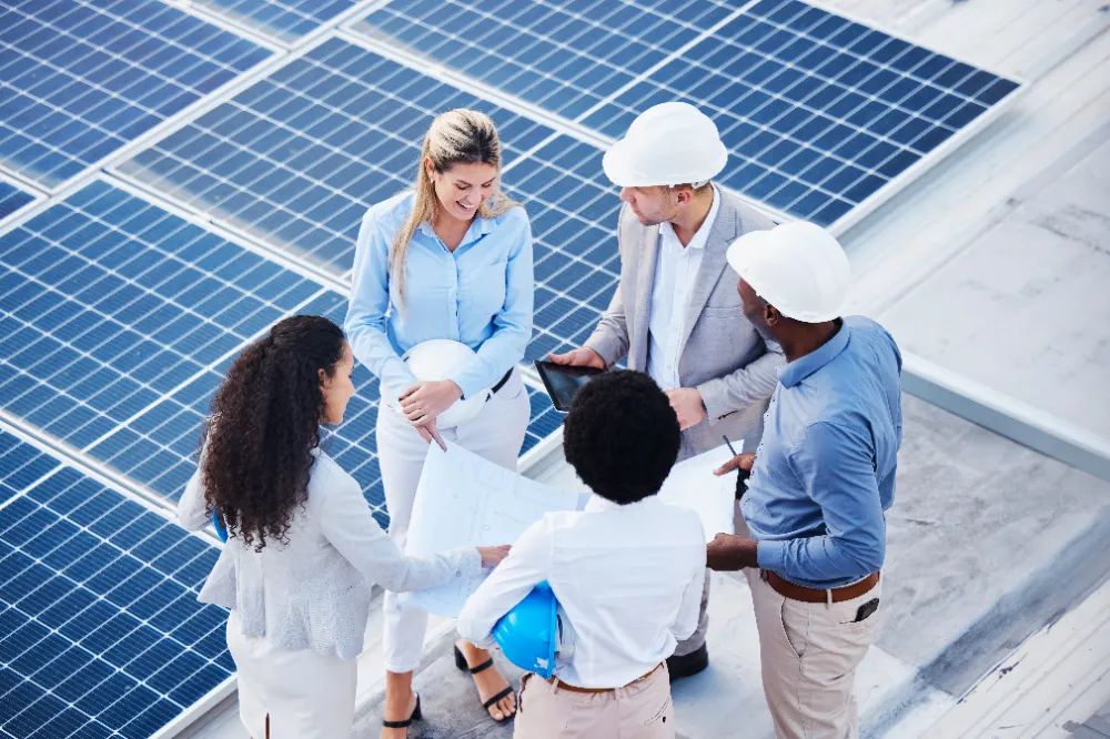 Group of colleagues talking at a solar plant