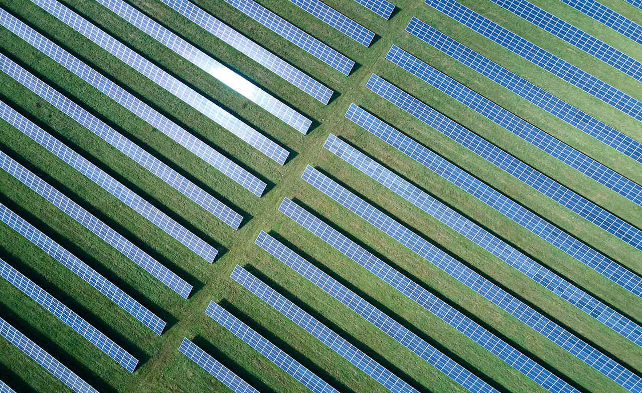 aerial view of a solar farm in a green field