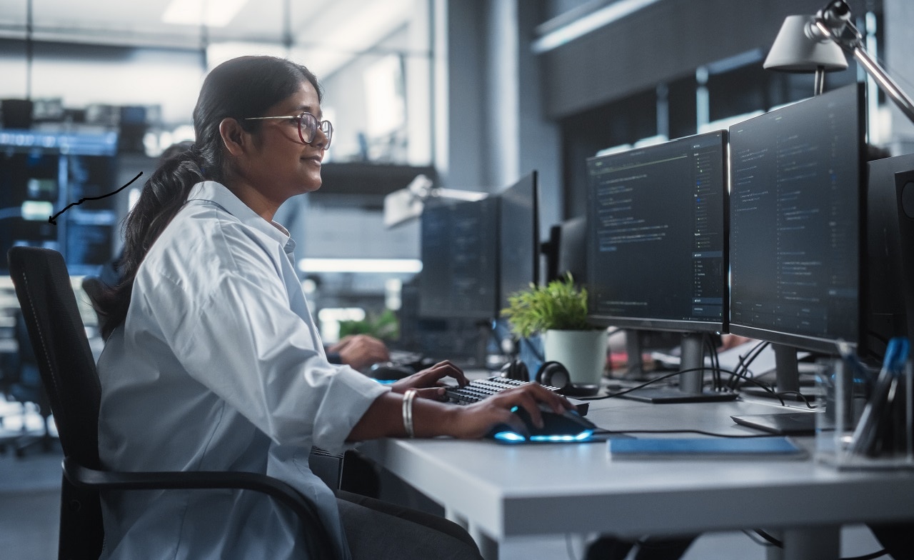 Woman working at dual monitors