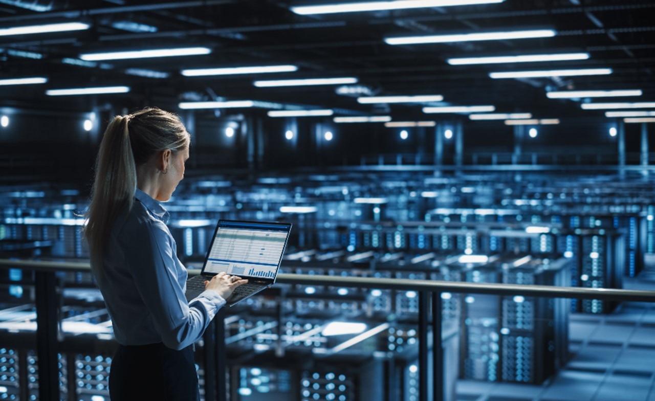 Woman using device to monitor warehouse